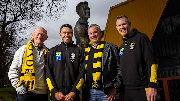 Tigers champions Kevin Bartlett, Shane Edwards, Francis Bourke, and Jack Riewoldt in front of the Jack Dyer statue at Punt Road Oval.