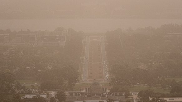 Wild winds dramatically reduced visibility in Canberra on Tuesday, blanketing Anzac Parade in dust. 