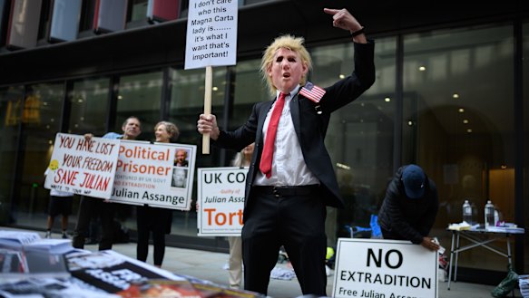 A man wears a Donald Trump mask as supporters of the Wikileaks founder Julian Assange gather outside the Old Bailey on September 14.