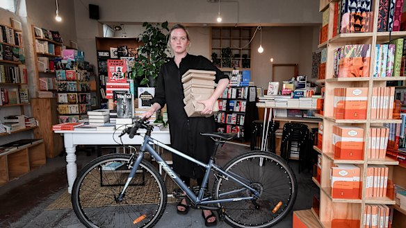 Neighbourhood Books owner Leesa Lambert has closed her store but now offers home delivery by bike or van to the local area. 
