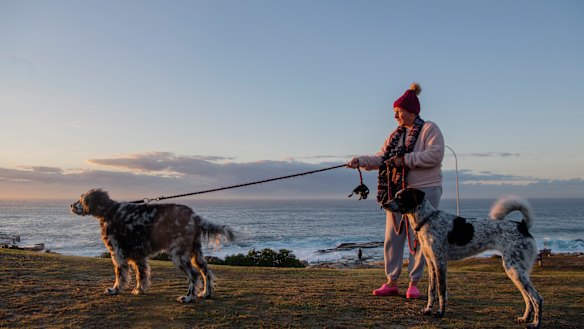 Penelope Earp walking her dogs Wilbur and Frankie at Maroubra. 