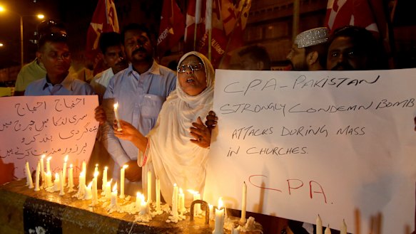 Pakistanis hold a vigil for the for victims of the Sri Lanka attacks, in Karachi, Pakistan.