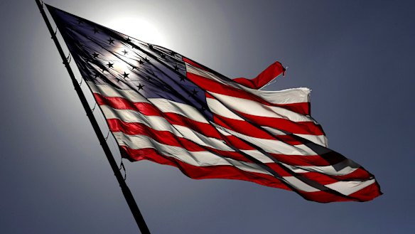 Strong winds from a cold front moving through Central Florida whip the massive American flag at Toyota of Orlando along Interstate 4, on the eve of the 2020 election.