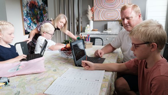 Rohan and Kelly De Carle say it is a balancing act between working and being engaged at home with their kids Eve, Nash and Jude.