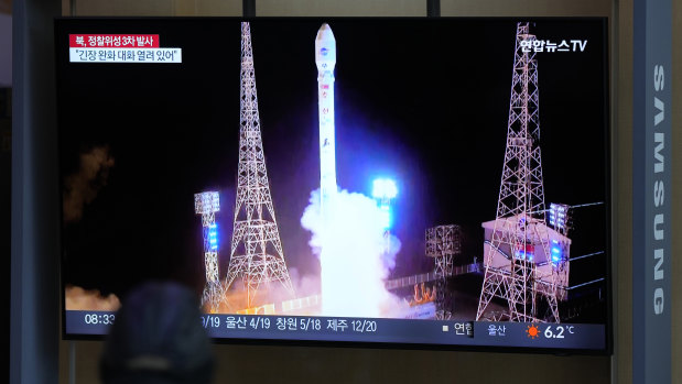 A TV screen in Seoul, South Korea, shows a report of the launch of North Korea’s spy satellite into orbit on Wednesday.