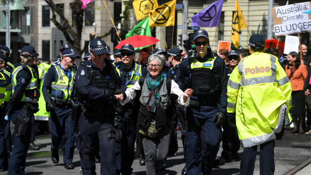 An Extinction Rebellion activist is arrested during a protest in Melbourne on Tuesday.