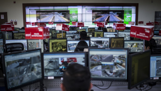 A control room of camera feeds and workers, part of Ecuador's Emergency Response System.
