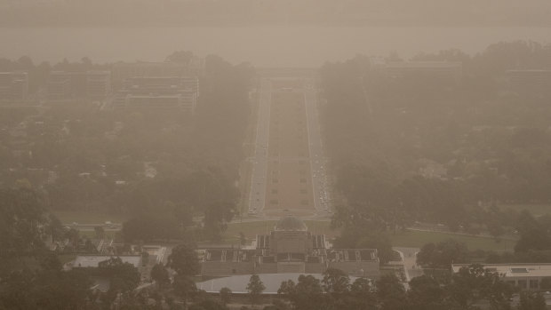 Wild winds dramatically reduced visibility in Canberra on Tuesday, blanketing Anzac Parade in dust. 