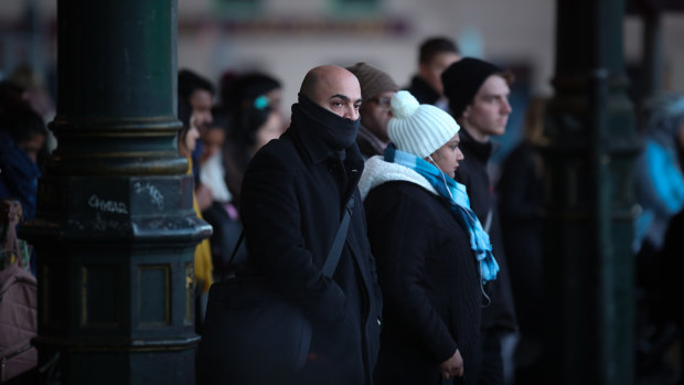 Commuters make their way to work in Melbourne on the coldest morning of the year so far.