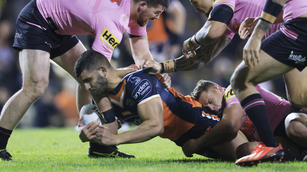 Alex Twal is tackled by the Panthers defence.