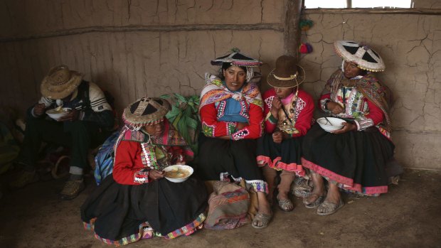 Andean muleteers break for lunch during a tour to Rainbow Mountain.