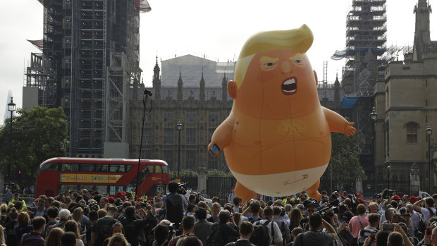 A six-meter high baby blimp of Donald Trump is flown as a protest against his visit, in Parliament Square backdropped by the scaffolded Houses of Parliament and Big Ben in London on Friday.