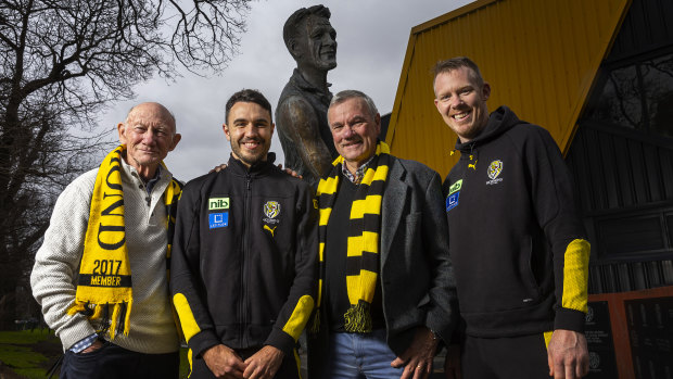 Tigers champions Kevin Bartlett, Shane Edwards, Francis Bourke, and Jack Riewoldt in front of the Jack Dyer statue at Punt Road Oval.