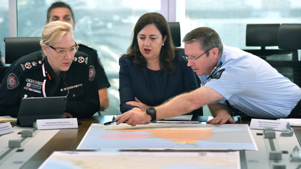 Queensland Fire and Emergency Services Commissioner Katarina Carroll (left), Queensland Premier Annastacia Palaszczuk (centre) and Queensland Police Deputy Commissioner Bob Gee (right) at a meeting of the Queensland Disaster Management Committee on Tuesday.