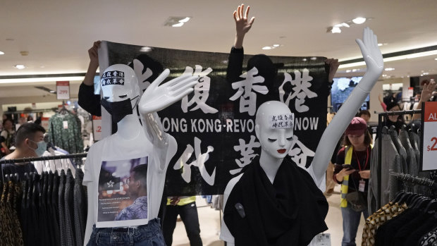 Pro-democracy protesters put masks and slogans on the mannequins at a fashion store in Harbour City shopping mall.