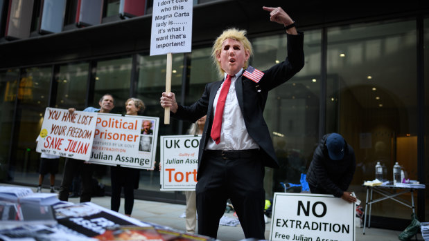 A man wears a Donald Trump mask as supporters of the Wikileaks founder Julian Assange gather outside the Old Bailey on September 14.