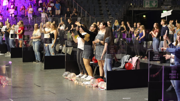 Germans attend a live concert in Cologne, Germany under social distancing restrictions. The hall has been equipped with plexiglas boxes, installed 2-3 meters apart from one another, and up to four people are allowed in each box.