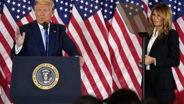 Donald Trump speaks in the East Room of the White House in Washington, as first lady Melania Trump listens, about 2.25am on Wednesday (US time).