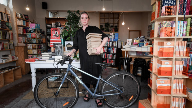 Neighbourhood Books owner Leesa Lambert has closed her store but now offers home delivery by bike or van to the local area. 