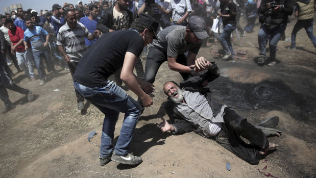 An elderly Palestinian man falls after being shot by Israeli troops at the Gaza Strip's border with Israel last year. Thousands of Palestinians  protested as Israel celebrated the inauguration of a new US embassy in contested Jerusalem. 