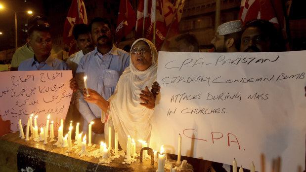 Pakistanis hold a vigil for the for victims of the Sri Lanka attacks, in Karachi, Pakistan.