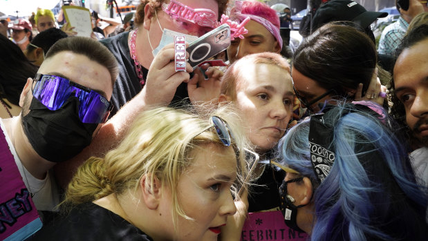 Britney Spears supporters listen to a feed from the courtroom outside a hearing in Los Angeles.