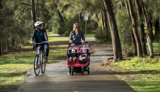 Jo Haylen, with children Dylan and Elliot, talks to a cyclist in Earlwood.