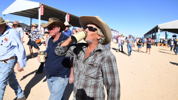 A racegoer drinks his beer at the Birdsville Races on Friday.