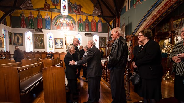 Effie is comforted by family and friends at her husband Apostolos’ funeral service at St Eleftherios Church in Brunswick.