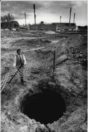 Mr. Noel Neate beside the well named "Busby's Bore" found during the construction of the Sydney Football Stadium, May 20, 1986. 