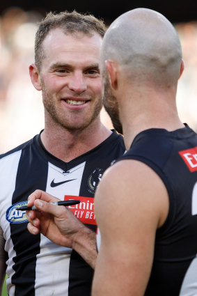 Collingwood’s Tom Mitchell with Sidebottom.