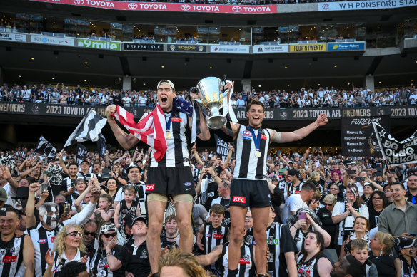 Collingwood celebrate with the 2023 AFL premiership trophy.