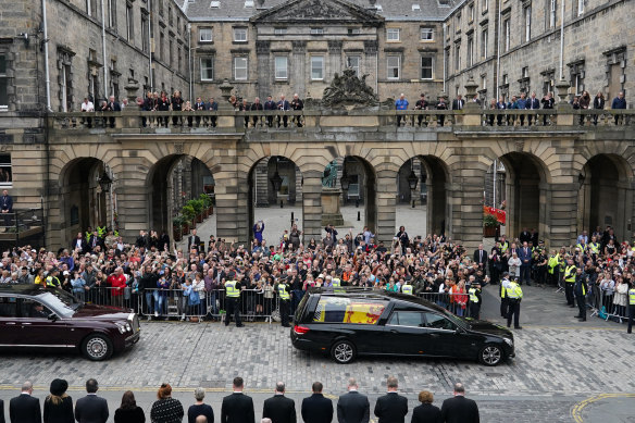 Crowds watch the cortege carrying the coffin of the late Queen Elizabeth II as it arrives in Edinburgh.