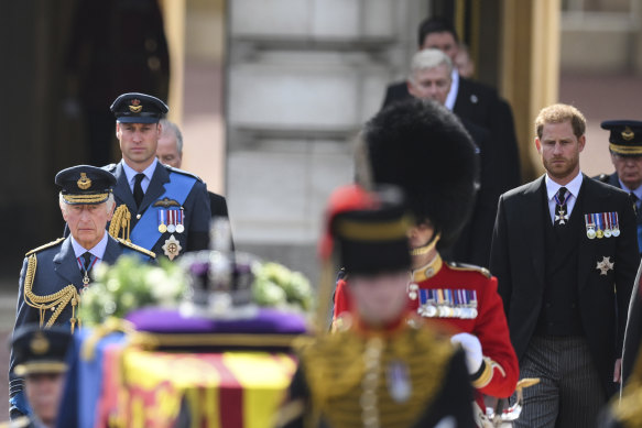 King Charles III, Prince William and Prince Harry walk behind the coffin during  a procession from Buckingham Palace to Westminster Hall. 