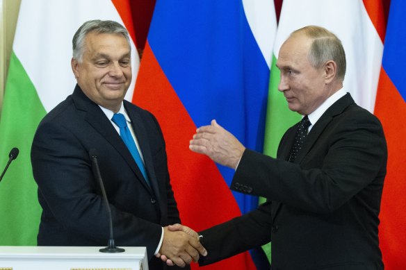 Too close? Russian President Vladimir Putin, right, shakes hands with Hungarian Prime Minister Viktor Orban in 2018 in Moscow.