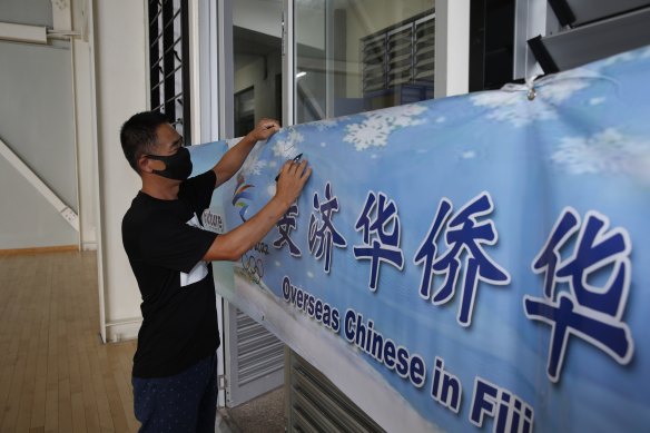 Zhao Fugang takes part in a banner-signing event to show support for the Beijing Winter Olympics in 2022.