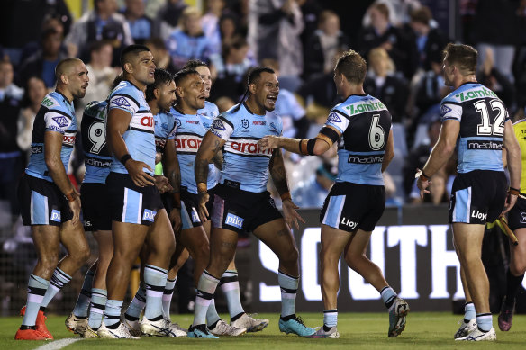 The Sharks celebrate after Briton Nikora scores.