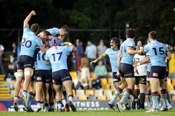 The Waratahs celebrate at full-time after knocking off the Crusaders at Leichhardt Oval.