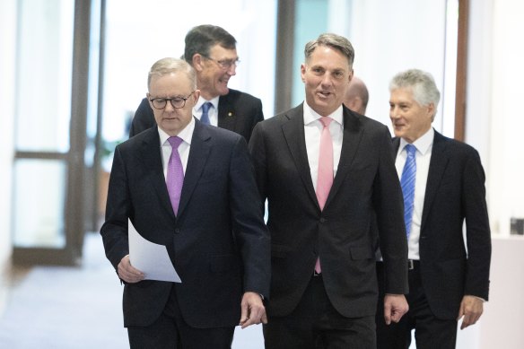 Prime Minister Anthony Albanese and Defence Minister Richard Marles lead former Defence chief Angus Houston and minister Stephen Smith into a press conference about the defence strategic review.