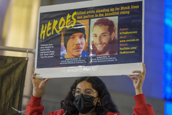 Luna Hernandez holds up a sign in Los Angeles, following the acquittal of Kyle Rittenhouse in Kenosha.