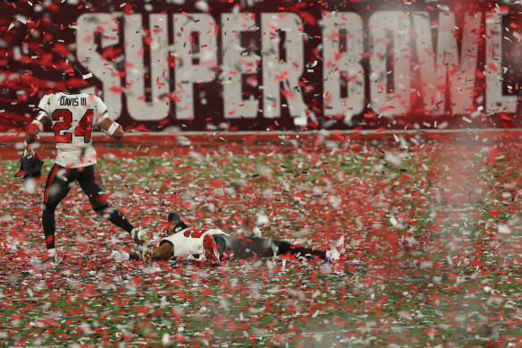 How sweet it is: Carlton Davis of the Tampa Bay Buccaneers runs through the confetti shower.
