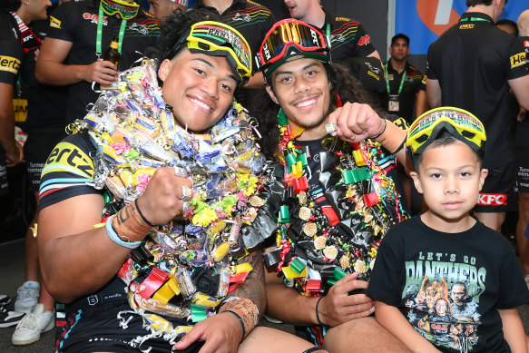 Panthers players Brian To’o and Jarome Luai celebrate their victory while wearing their candy leis.