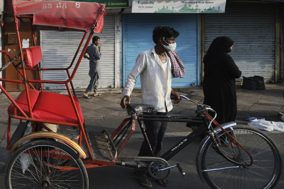A rickshaw puller waits for customers in New Delhi.