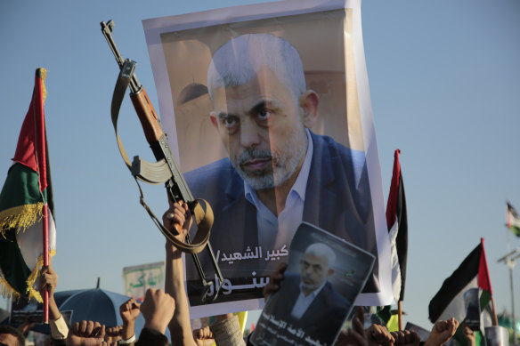 Supporters raise a poster of Hamas leader Yahya Sinwar, who was killed by Israeli troops in Gaza.