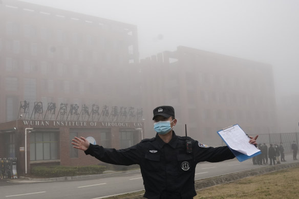 A security person moves journalists away from the Wuhan Institute of Virology in February after a World Health Organisation team arrived for a field visit in Wuhan in China’s Hubei province. 