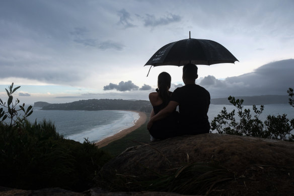 Stormy weather approached Palm Beach as Bianca Wong and Nathan Au watched from Barrenjoey Lighthouse.