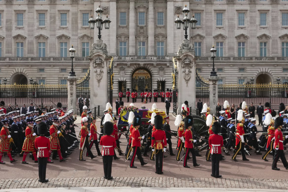 The coffin of Queen Elizabeth II passes Buckingham Palace on Monday.