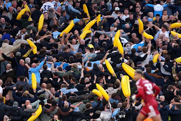 Manchester City fans celebrate their teams first goal scored by Erling Haaland.