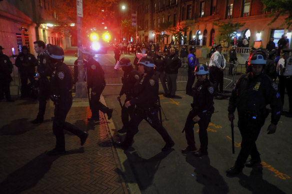 Members of the New York police strategic response team move towards an entrance to Columbia University.