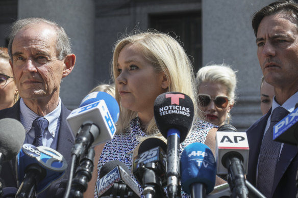 Virginia Roberts Giuffre, who says she was trafficked by Jeffrey Epstein, holds a news conference outside a Manhattan court with her lawyer in August, 2019.